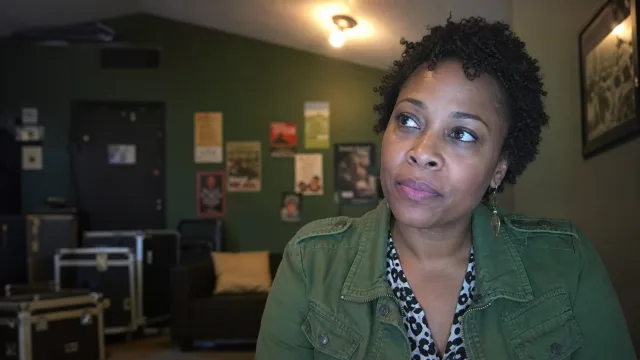 A music promoter listening from a venue green room