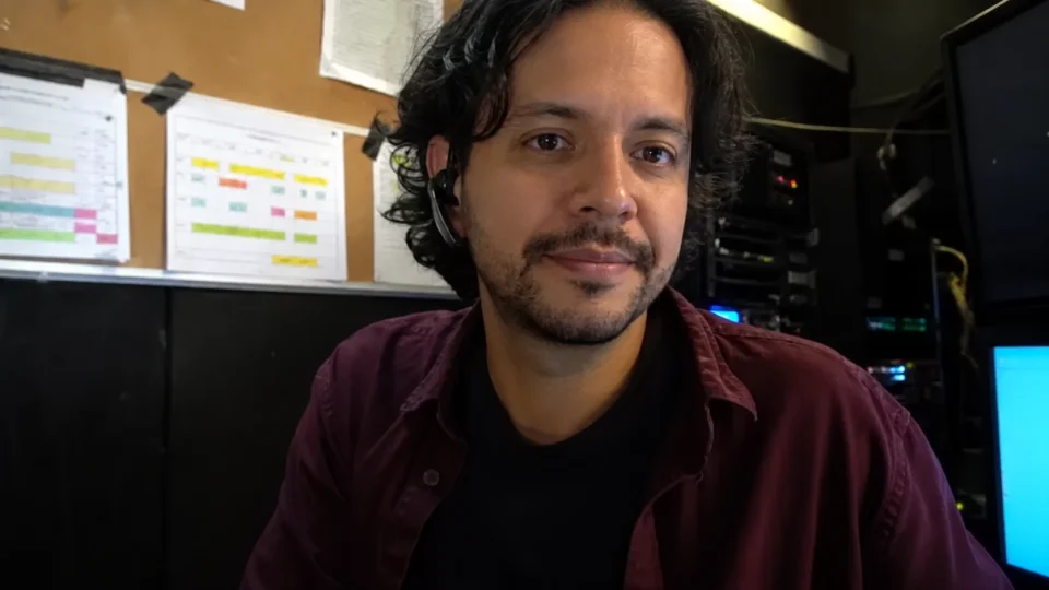 A talent buyer listening attentively from a backstage production office